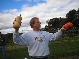 Kevin showing a button bottom and a peanut shaped squash